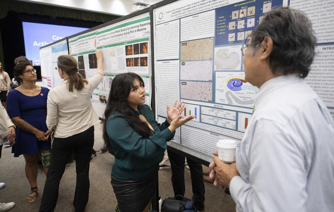 Student presenting her research at the Creative Activities & Research Symposium.