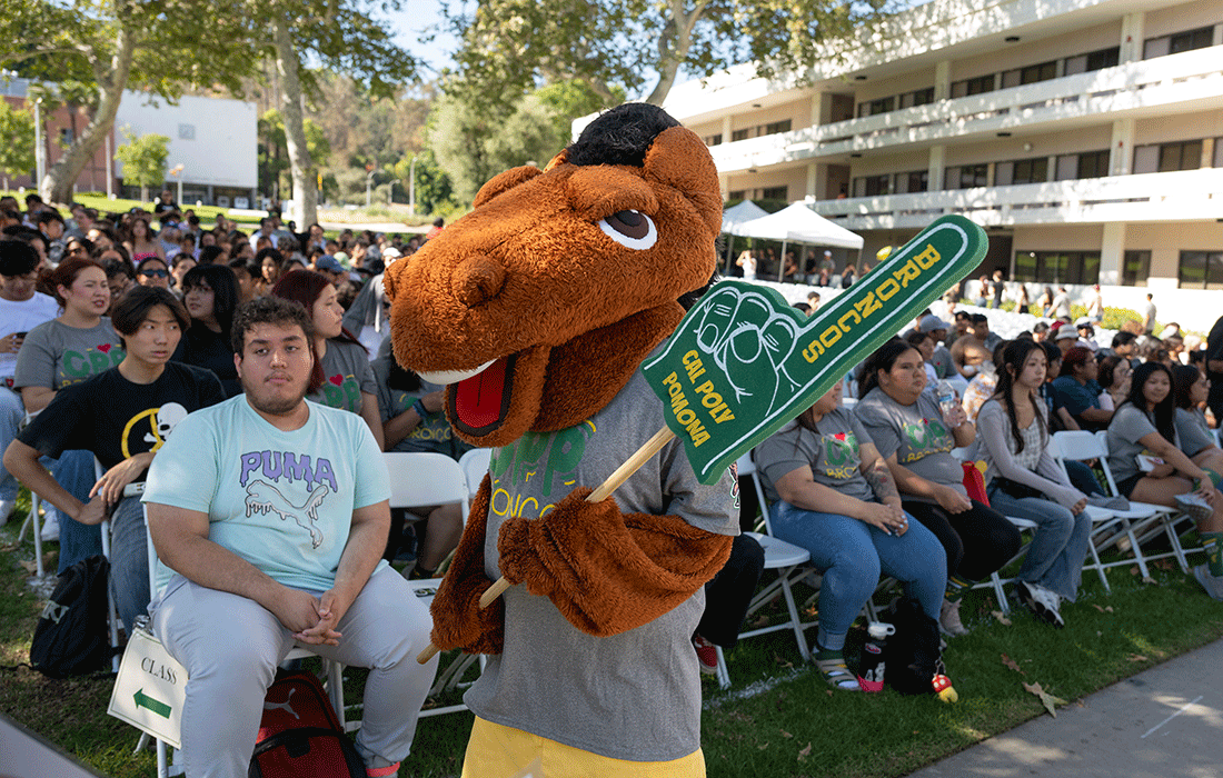Billy Bronco holds a Broncos finger sign