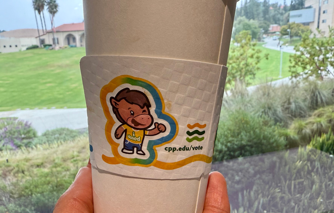 A cupsleeve showing Billy Bronco with the words I Voted