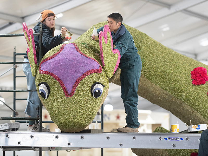 Two students decorate Nessie the Lochness Monster