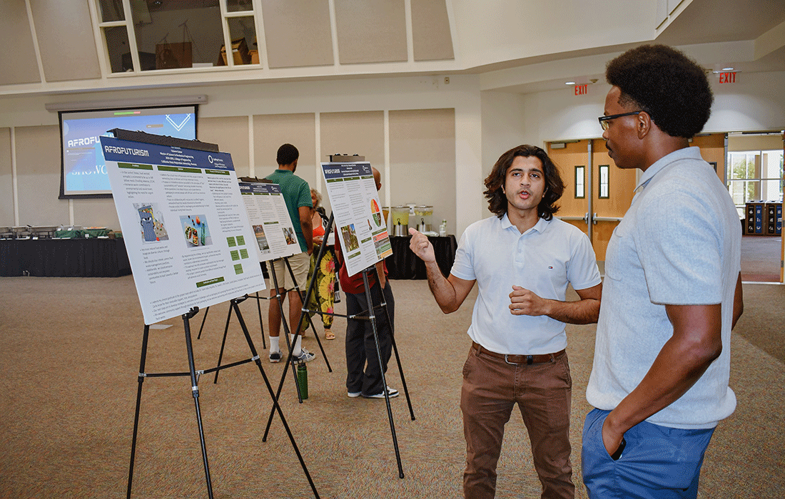 Faheem speaks about Afrofuturism during a research conference.