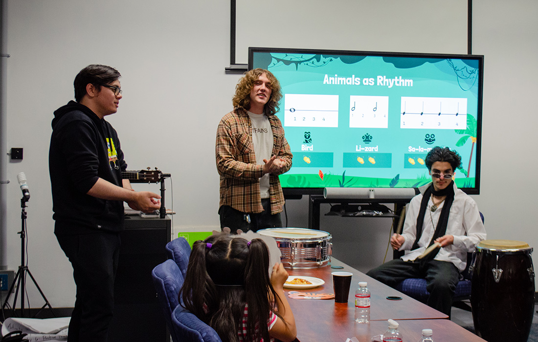 Center for Community Engagement students work with Children in a classroom.