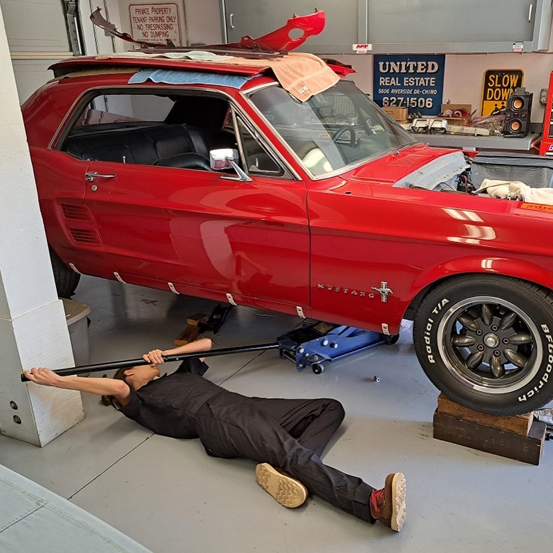 Laila Quezada works on a red Mustang