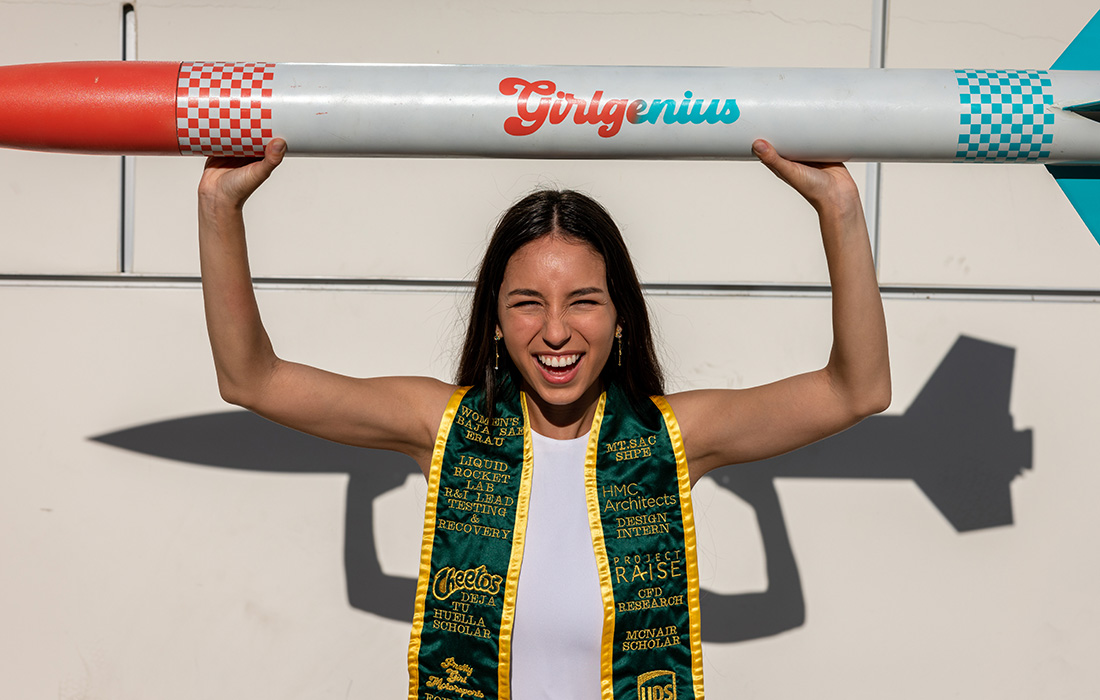 Laila Quezada holds a rocket that says Girl Genius