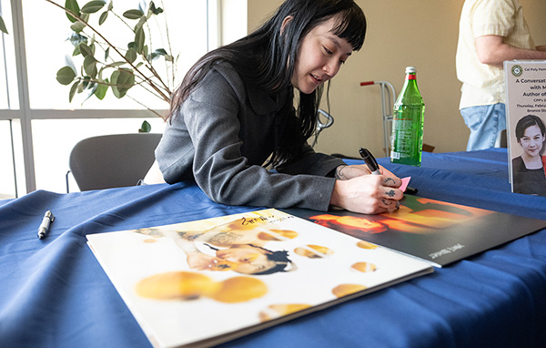 Michelle Zauner signs copies of her book. 