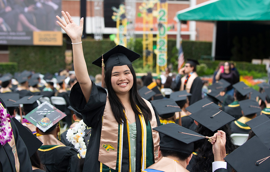Lana Hy Smiles as she walks the commencement stage.