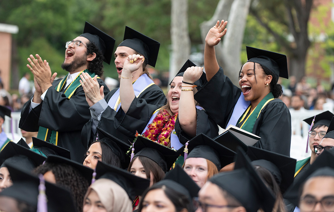 A diverse group of students celebrate in their seats during the 2025 Commencement ceremonies.
