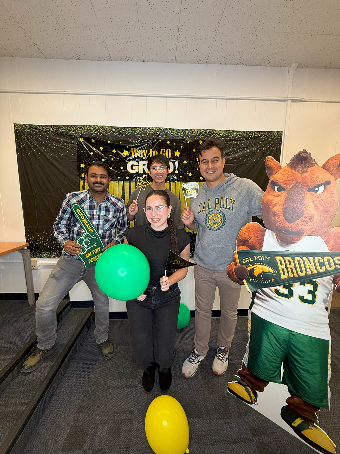4 Students pose with a Billy Bronco cardboard cutout.