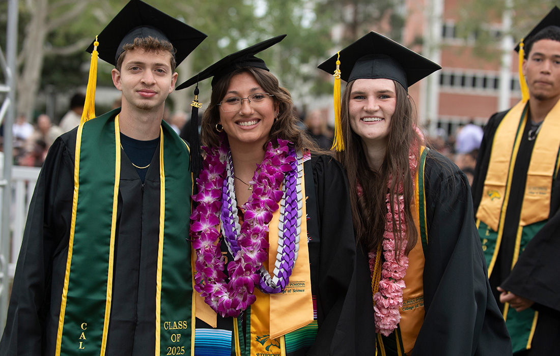 Three College of Science grads smile
