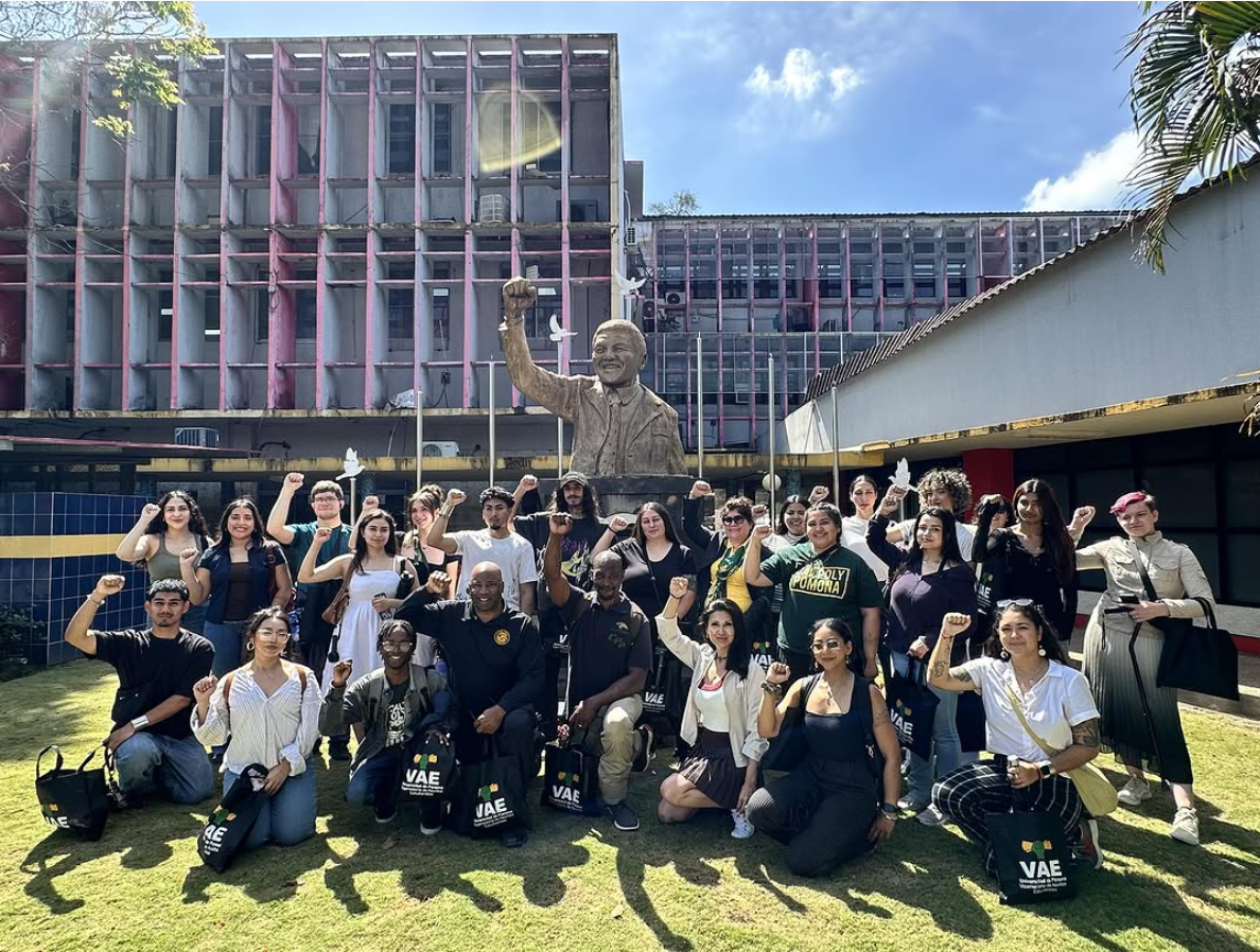 Study abroad group posing alongside the Nelson Mandela statue