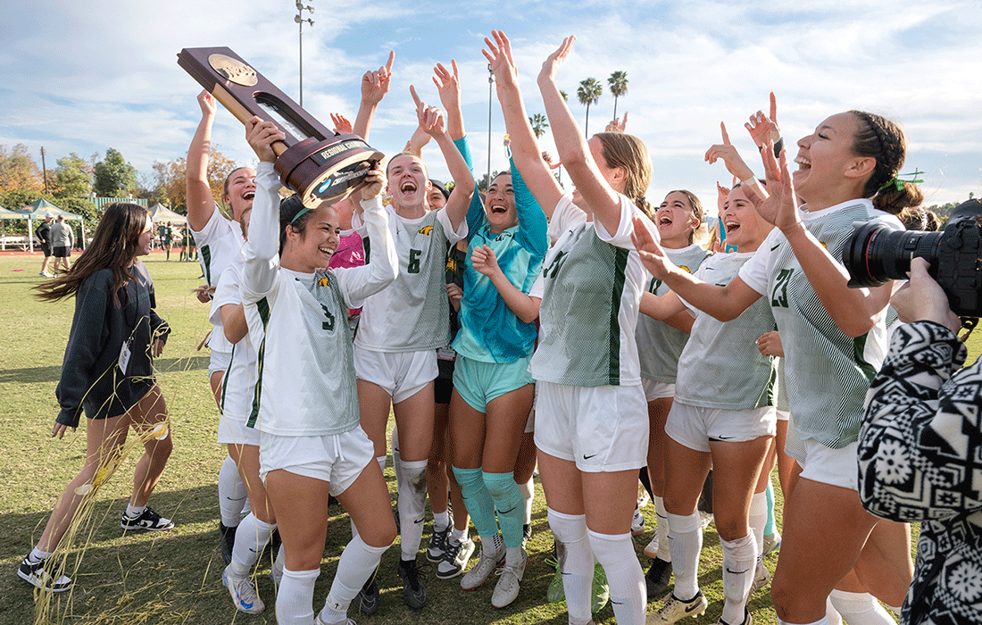 The Women's Soccer team celebrates winning the CCAA Trophy