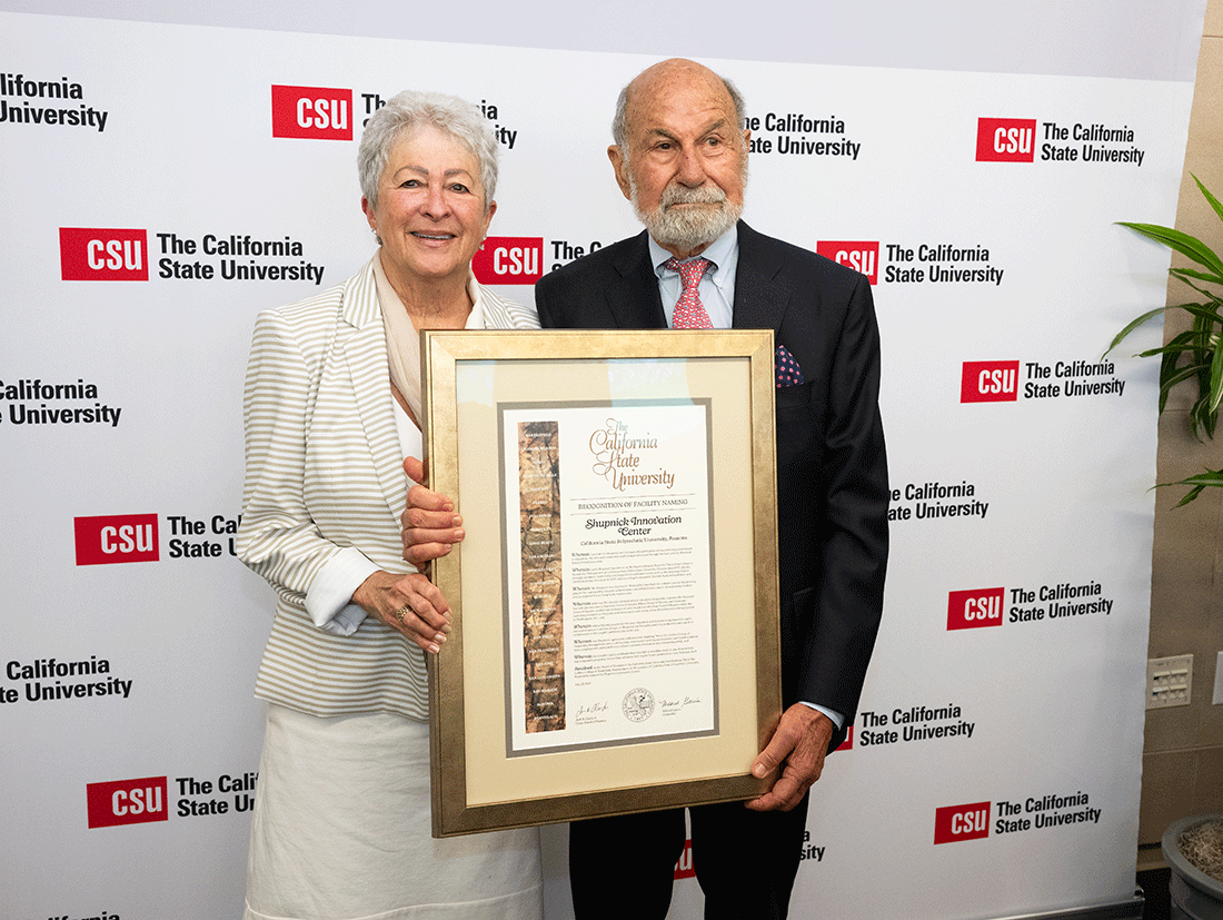 Jo and Larry Shupnick holding a plaque