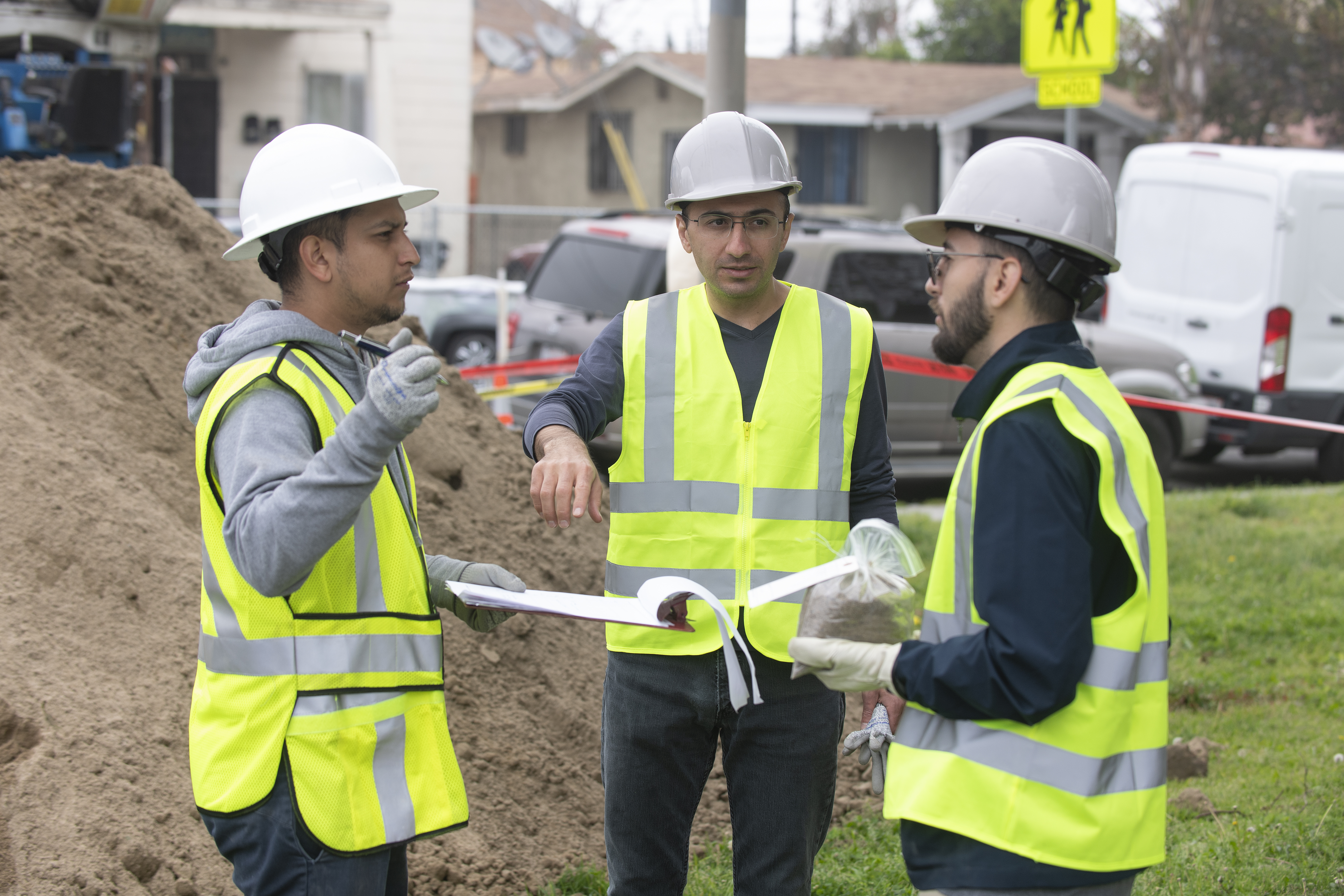 Students at a drilling site go over plans