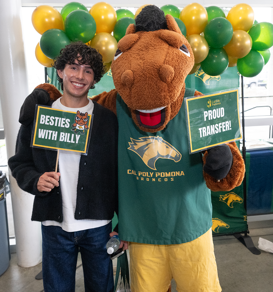 Male Chaffey transfer student poses with Billy Bronco.
