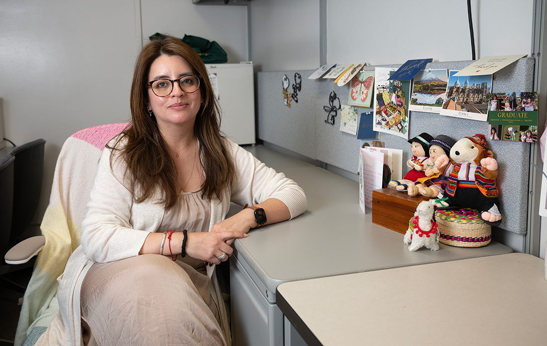 Denisse Vasquez Guevara sits at her desk.