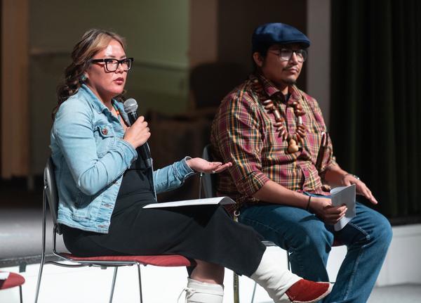 Erica Ben speaking in front of an audience