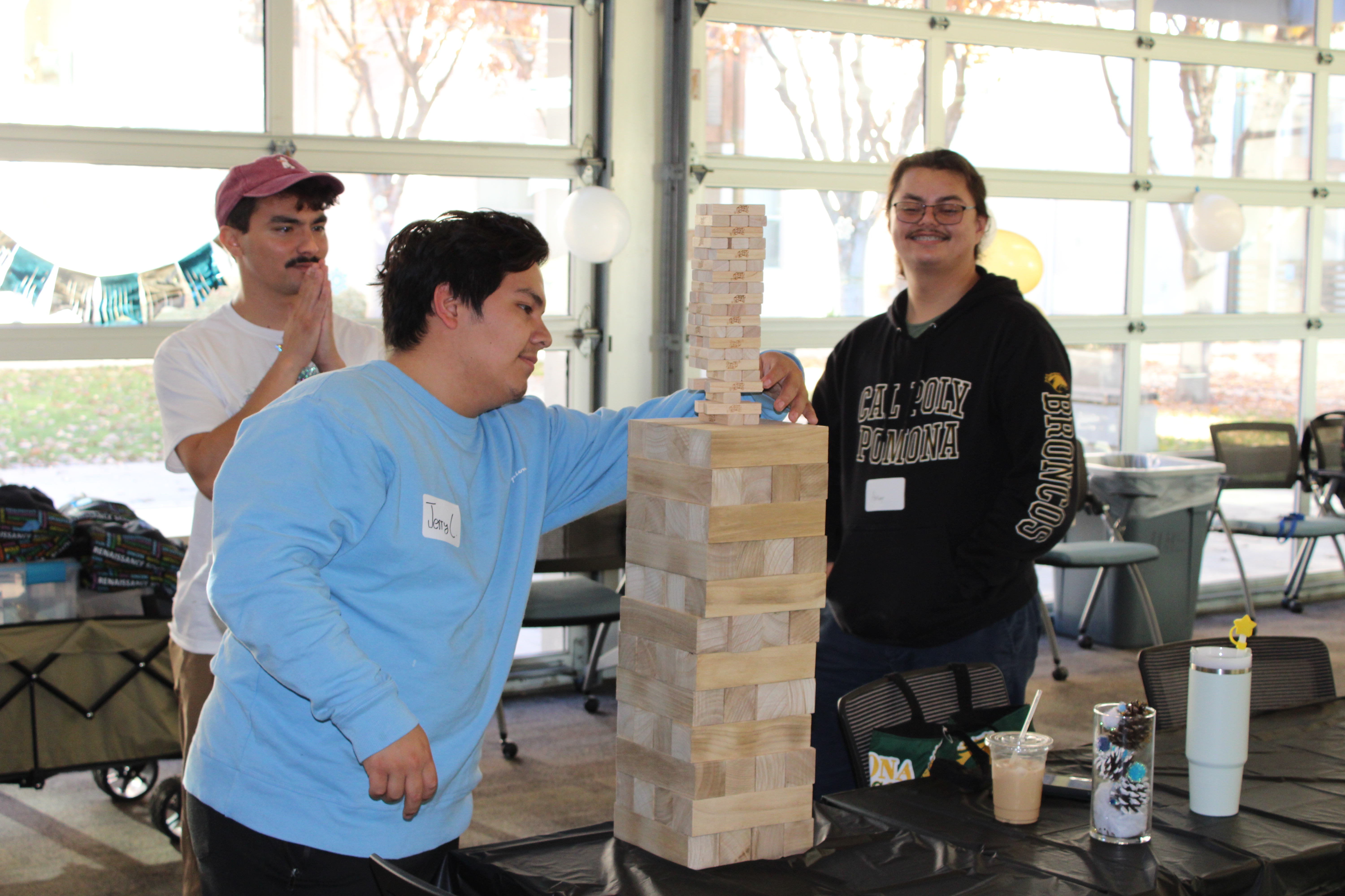 Michael Miser plays Jenga with two other students