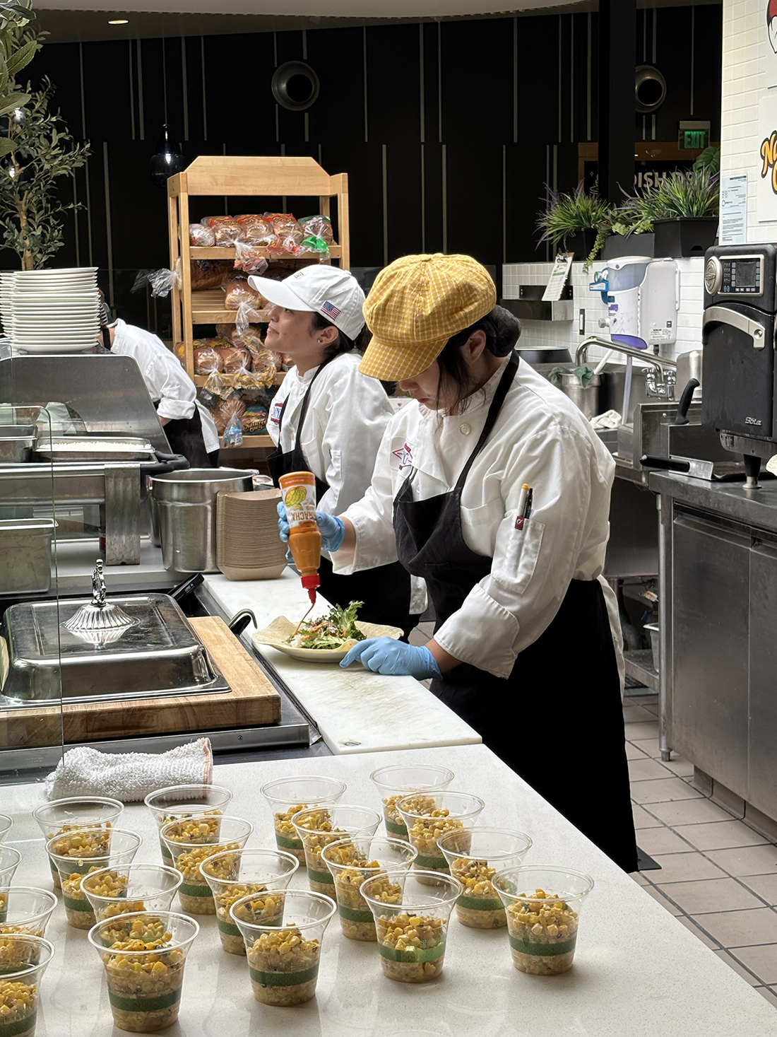 Students create an assembly of wraps and bowls in preparation for lunch at CenterPointe.