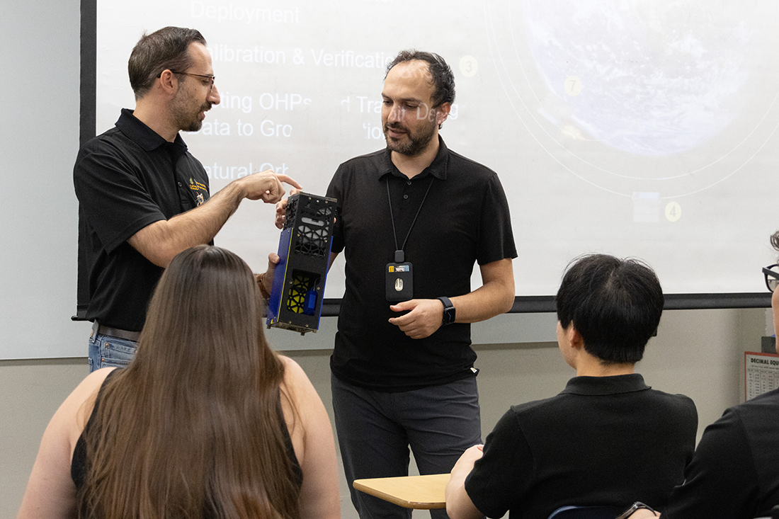 Professor Nakhjiri in discussion in a laboratory. 