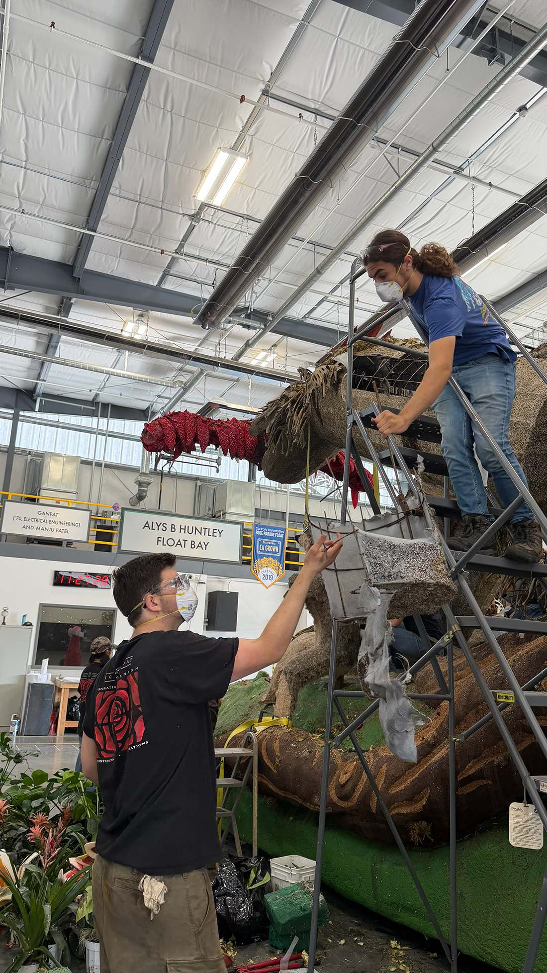 Two CPP students dismantle the floats Macaw