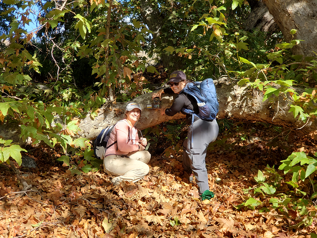 Two female students set up a camera during Womxn in the Wild excursion.