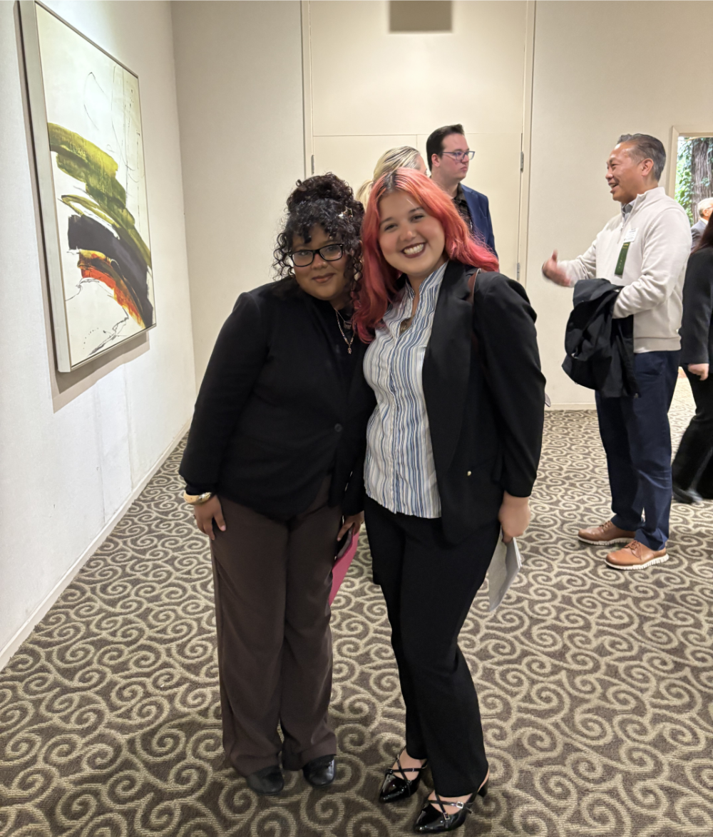 Two female students pose for a photo.