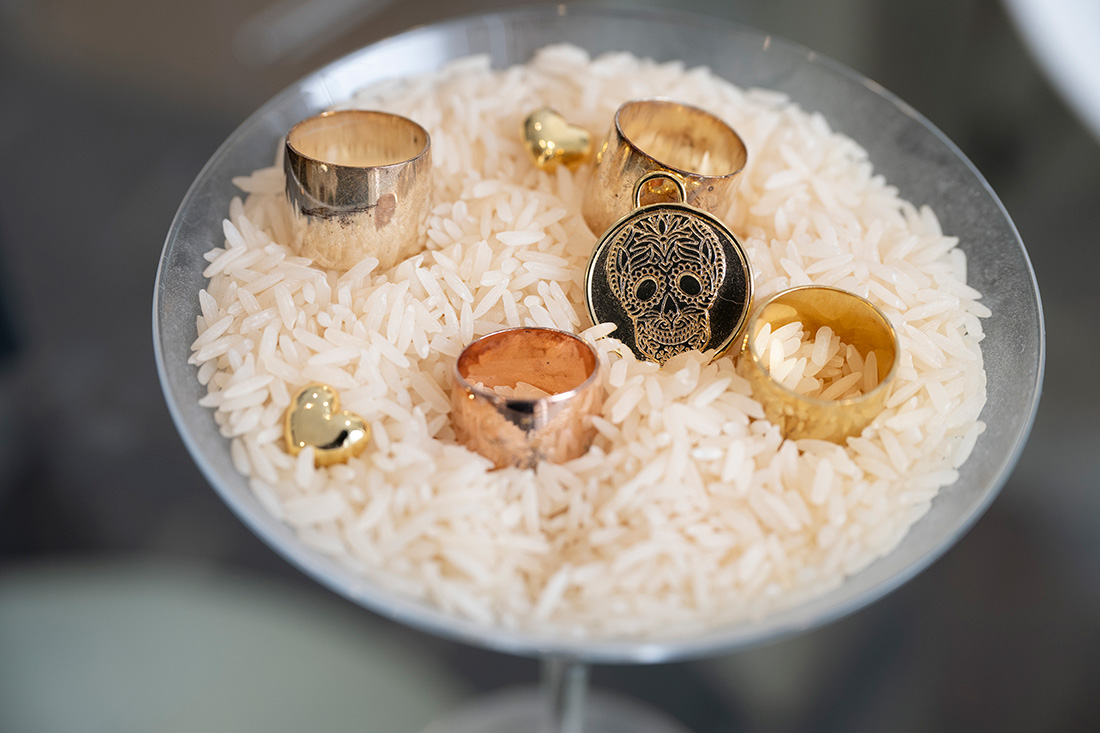  martini cup filled with Rice and designer rings. 