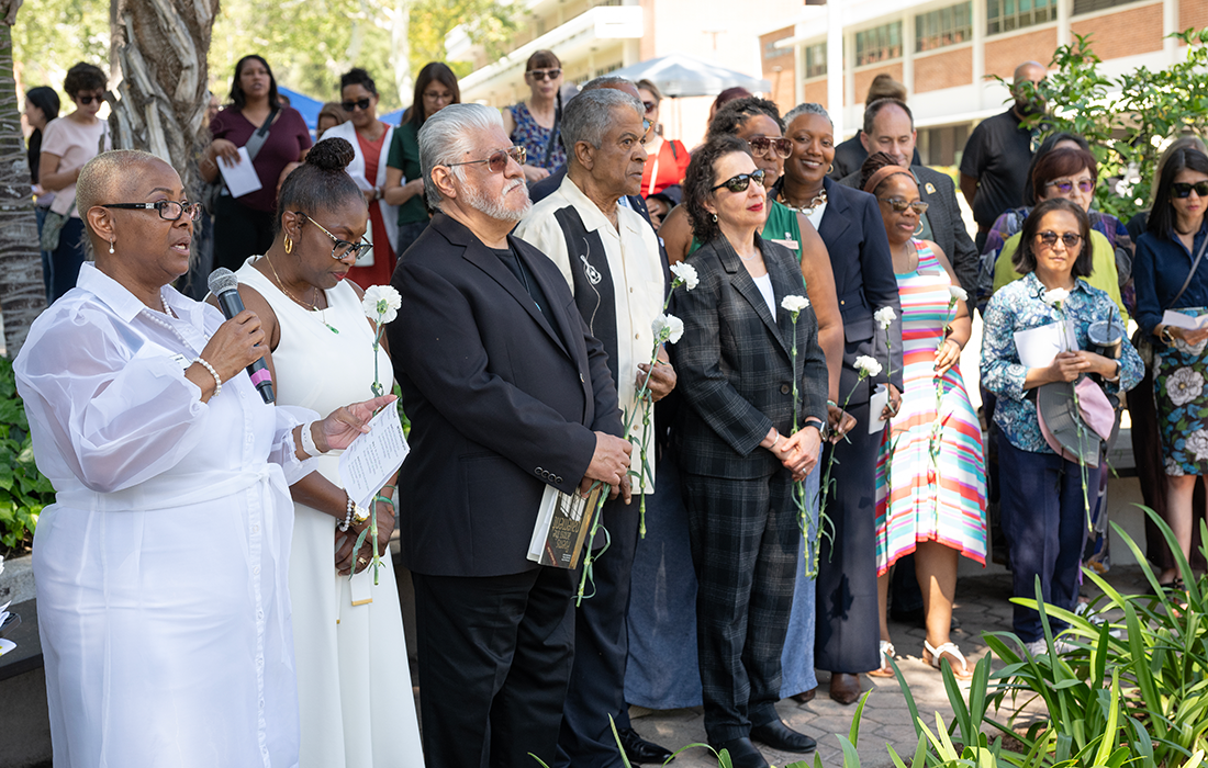  Participants in a group listen during the Monmument to Movement event. 