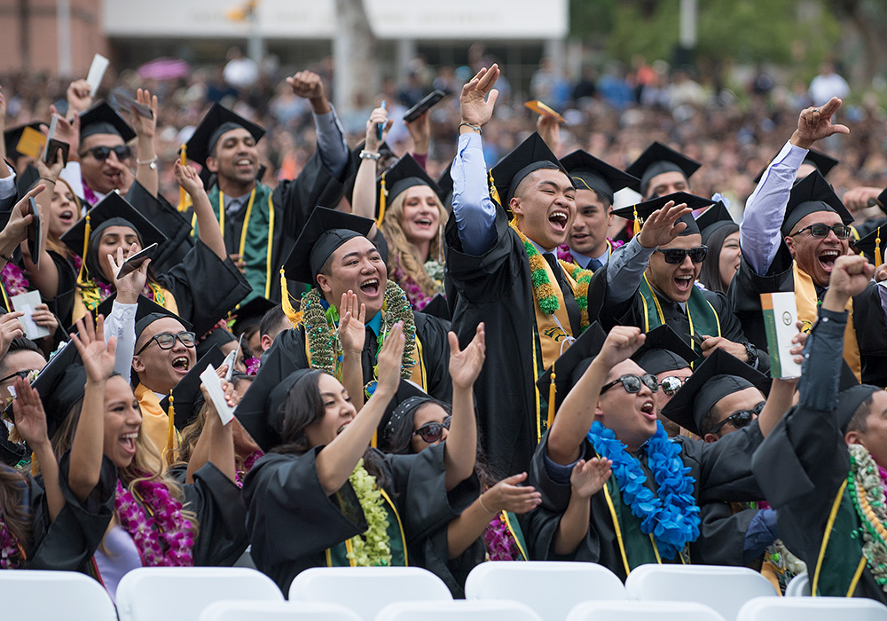 A group of students cheer and celebrate during commencement ceremonies