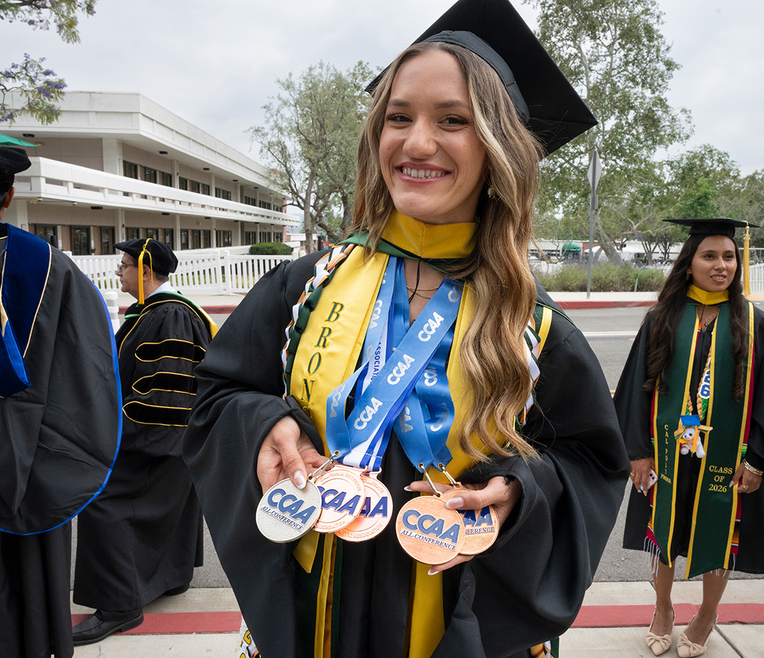 Female graduate wears her Bronco Athletics NCAA medals around her neck