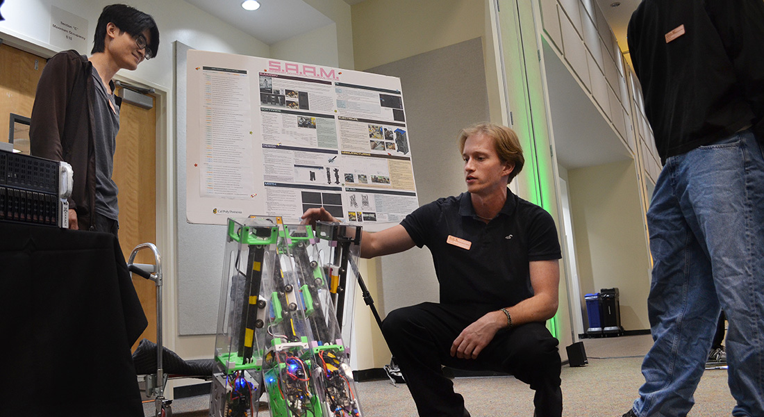 A student demonstrates SAAM - Somwhat Advanced Automomous Machine