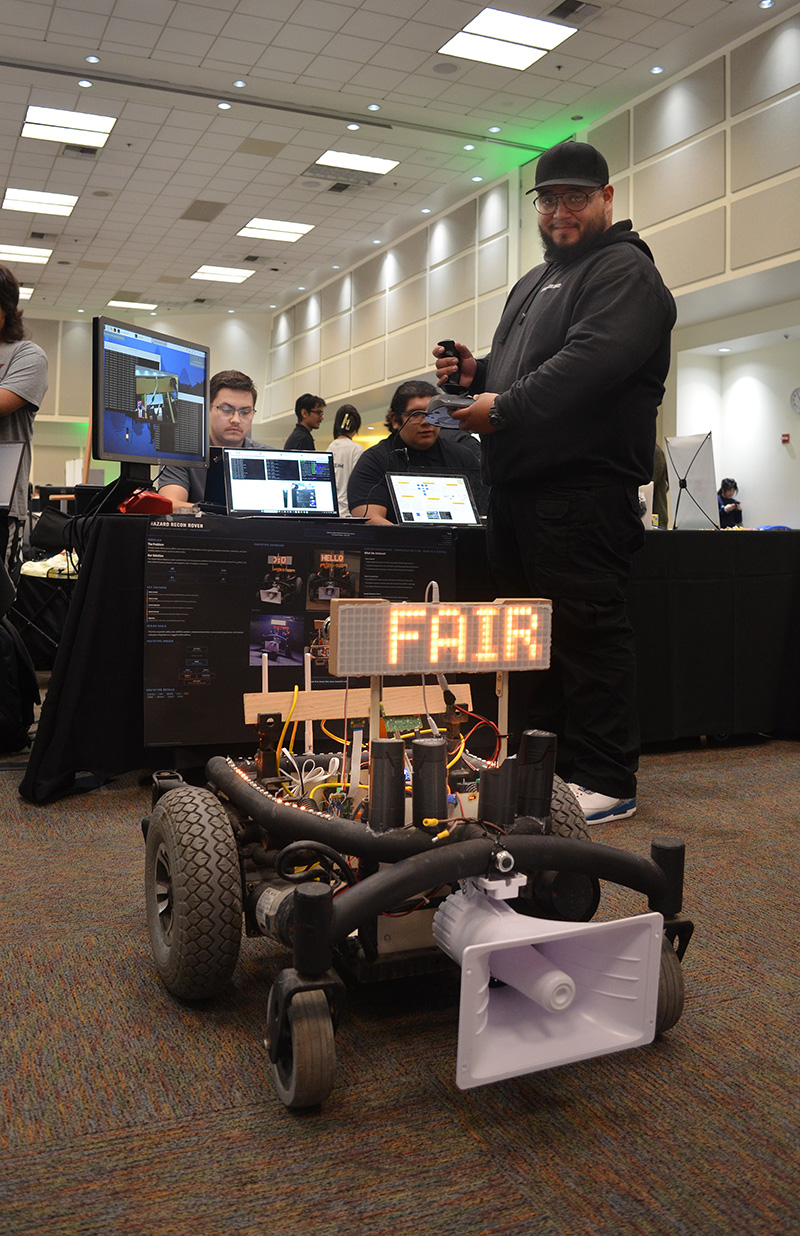 Male student with a robot that says 