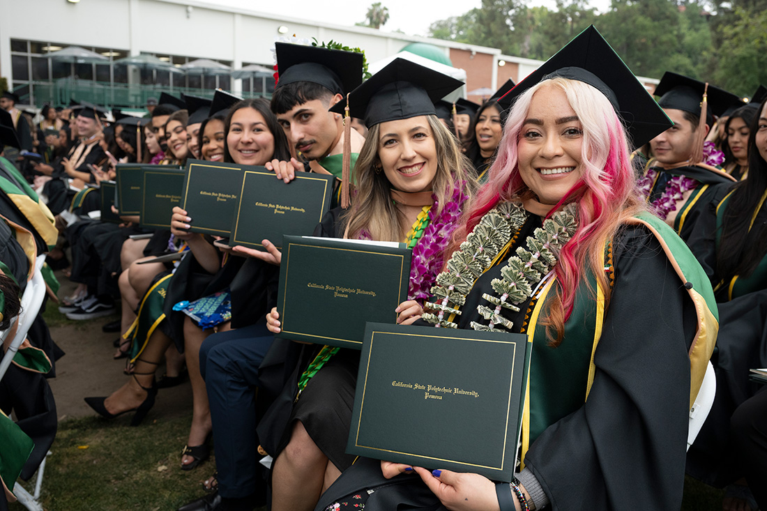 Lorraine Fernandez and College of Business Grads smile during the 2026 commenement ceremonies.
