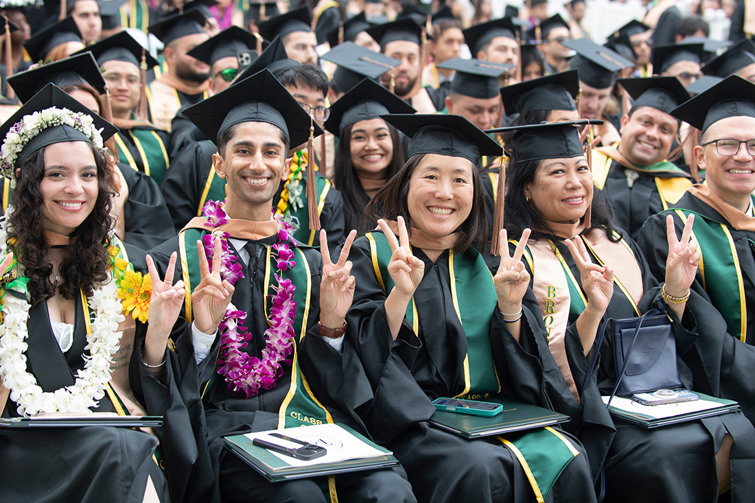College of Business Graduates smile for the camera during the 2026 commencement ceremonies.