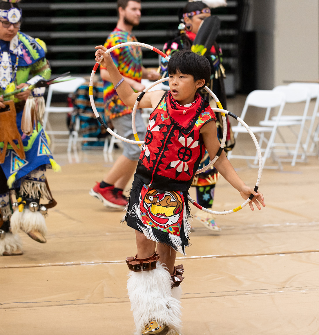 Young boy performs during the Powwow