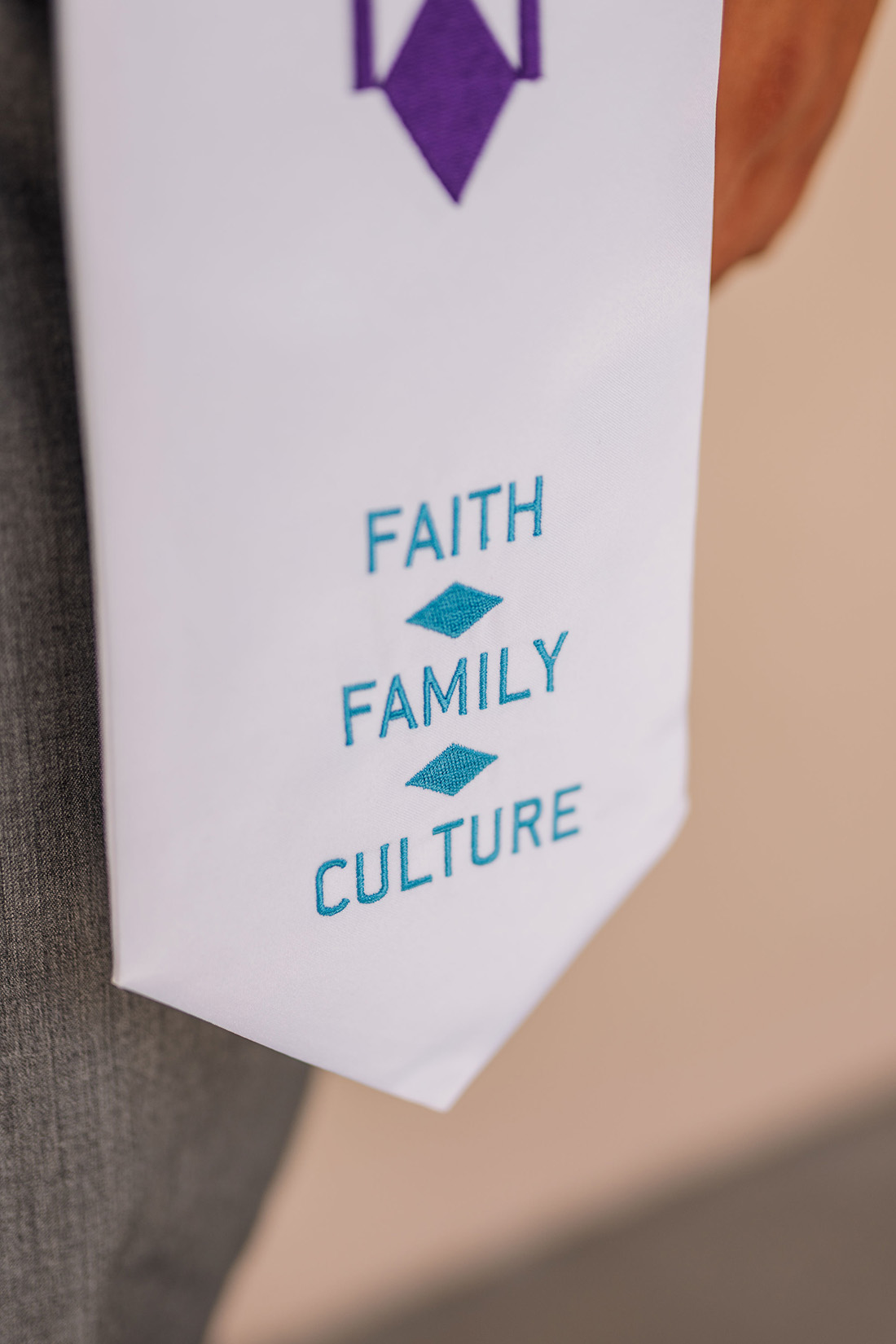 Faith, Family and Culture sewn onto Justin Mills' Grad stole.