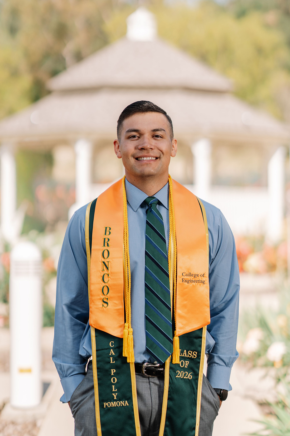 Justin Mills smiles in front of the Rose Garden. 