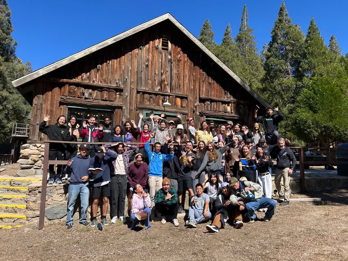 Sofia Perez with classmates in front of a cabin. 