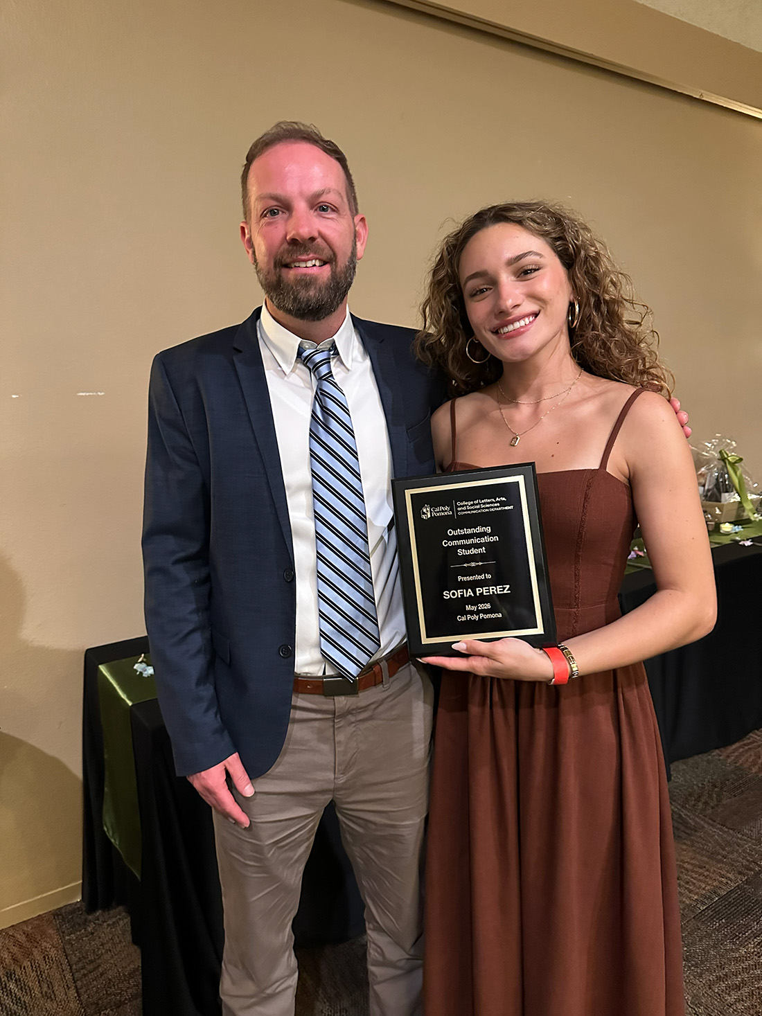 Sofia Perez holds an award given to her by department chair Jason Turcote.