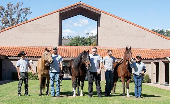 eterans with horses in front of the W.K. Kellogg Arabian Horse Center 