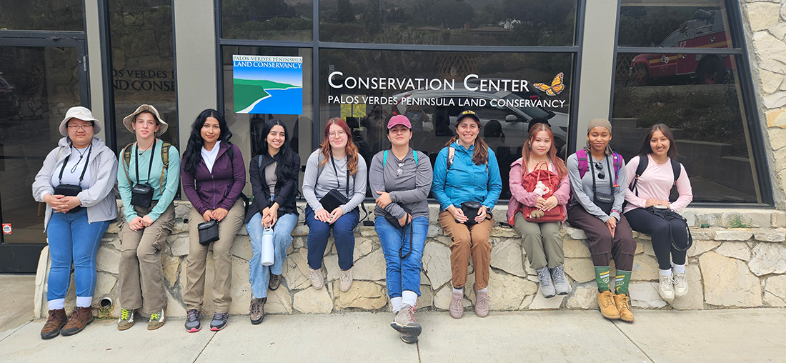 The 2026 Womxn in the Wild Cohort sit in front of the PalosVerdes Peninsula Land Conservancy Conservation center.