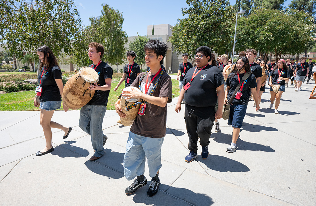 A Drum line walks through campus during CSSSA at CPP.
