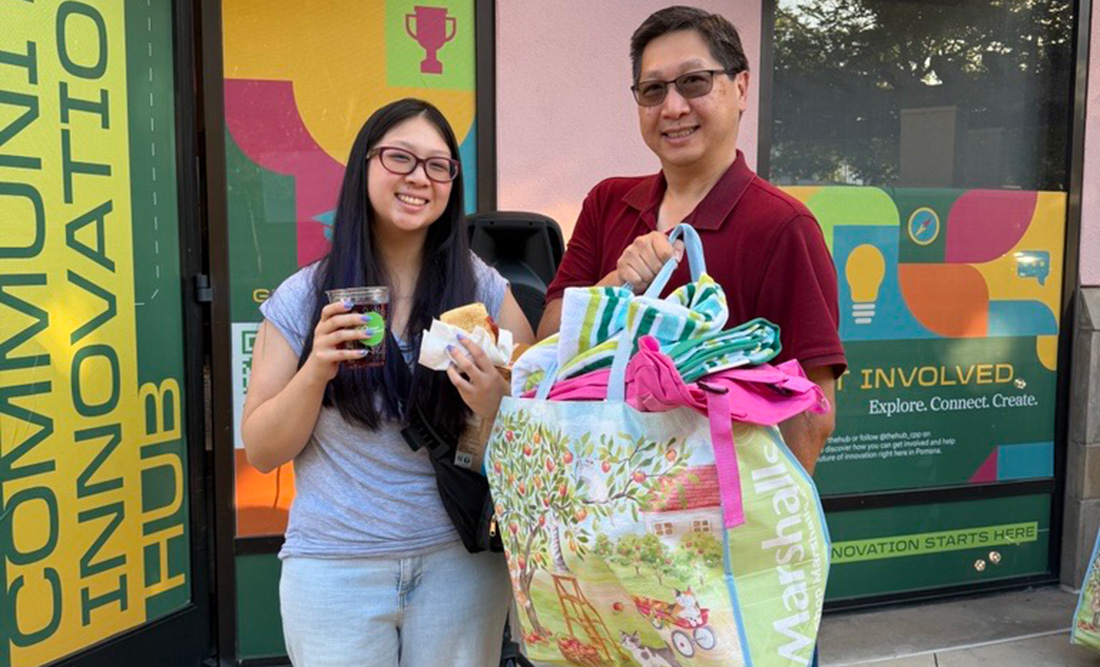 Staff memebers smile during Back-to-School Dorm Supply Giveaway