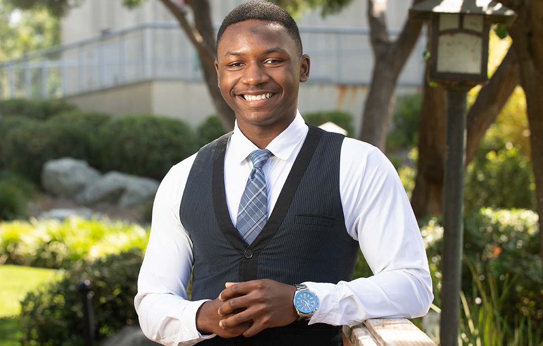 KeJuan Jones smiles while standing on the Aratni Japanese Garden on campus.