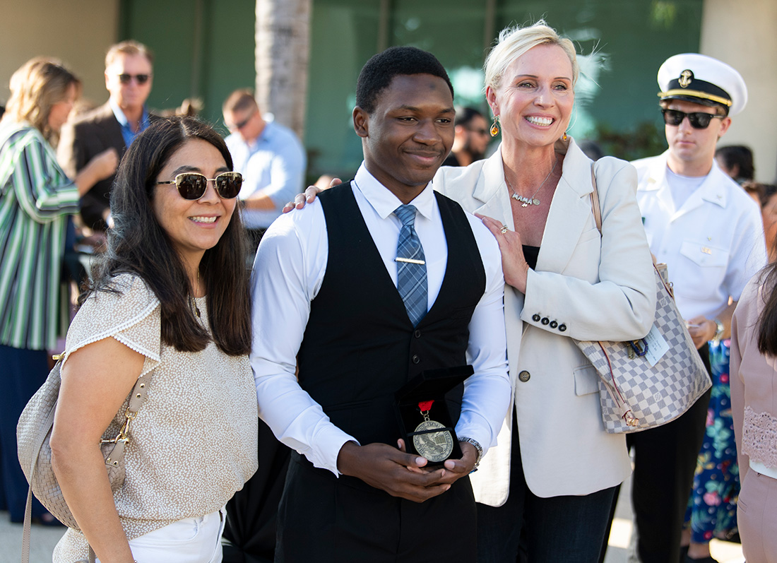 KeJuan Jones with a couple of his middle school teachers.