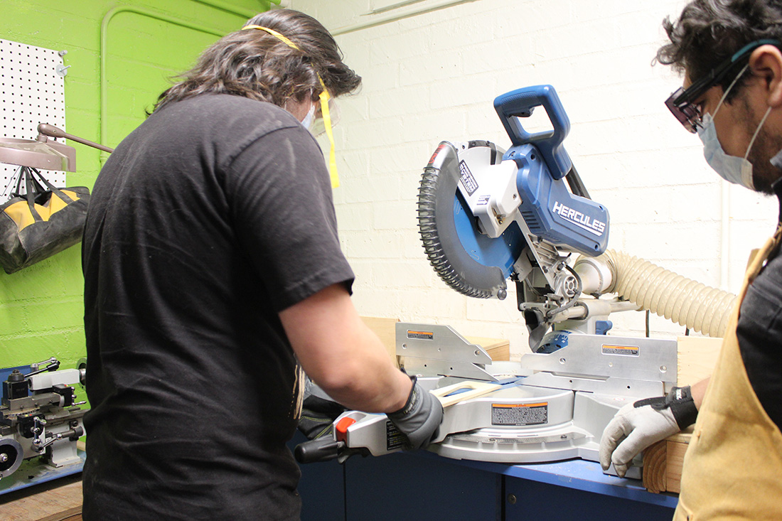 Male student works on cutting machine