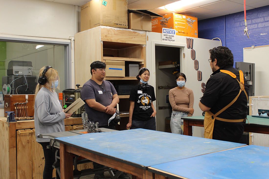 Four students get a tutorial from an Innovation Orchard expert.