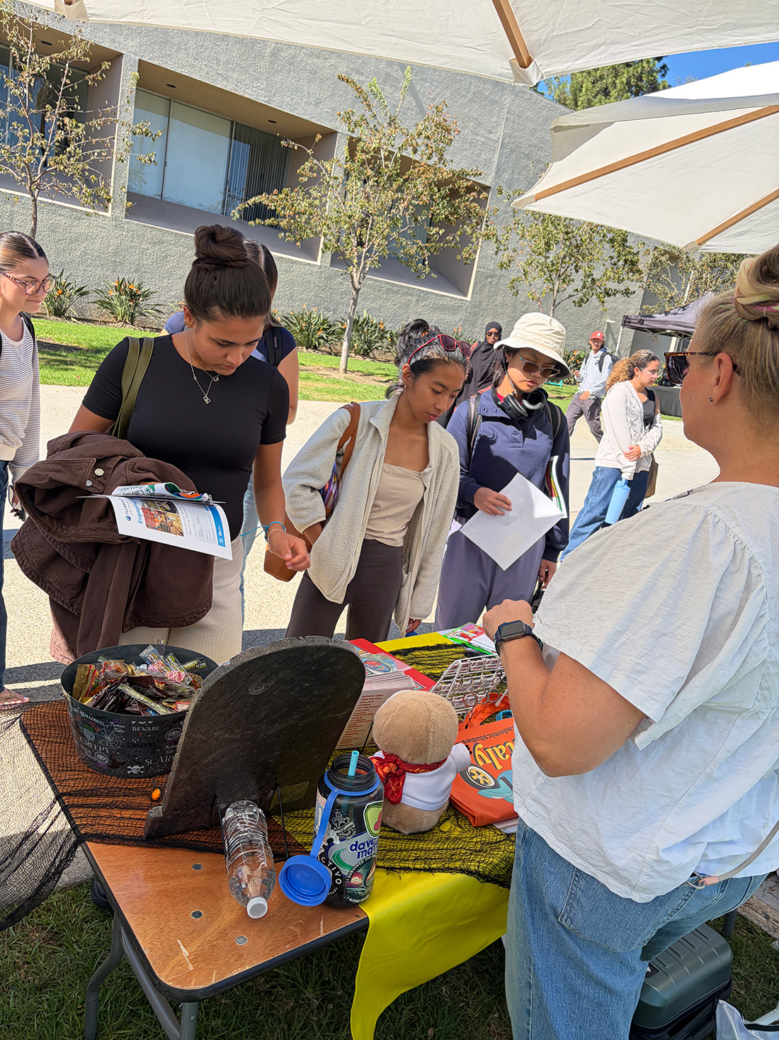 Campus Community stops by the Study Abroad Fair and participate in an activity at a table.