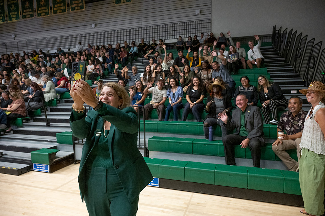 President Vanya takes a selfie with the crowd during her 100 Day celebration in Kellogg Gym.
