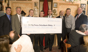 Daniel Andrews donates a check for a $105,000 during Hot Stove Dinner with Angels manager Mike Scioscia.